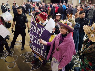 Security escorts Raging Granny protesters from a Rebel Media's anti carbon tax rally held at the Westin Hotel in Calgary on Sunday December 11, 2016.