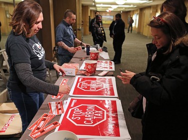 Signs and bumper stickers were being sold at an anti carbon tax rally held at the Westin Hotel in Calgary on Sunday December 11, 2016.