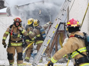Calgary firefighters put out a garage and home fire on Pensacola Close S.E. on Sunday December 11, 2016. No one was injured in the blaze after neighbours alerted the residents and several pets were rescued from the fire. GAVIN YOUNG/POSTMEDIA