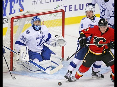 Calgary Flames winger Micheal Ferland jostles for position with the Tampa Bay Lightning's Tyler Johnson in front of goaltender Ben Bishop during NHL action against the the Tampa Bay Lightning at the Scotiabank Saddledome on Wednesday December 14, 2016.