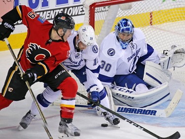 Tampa Bay Lightning goaltender Ben Bishop and centre Cory Conacher block the Calgary Flames' Matthew Tkachuk during NHL action against the the Tampa Bay Lightning at the Scotiabank Saddledome on Wednesday December 14, 2016.
GAVIN YOUNG/POSTMEDIA