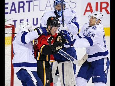 Tampa Bay Lightning goaltender Ben Bishop, centre Cory Conacher and defenceman Braydon Coburn tangle with block Calgary Flames' Matthew Tkachuk during NHL action against the the Tampa Bay Lightning at the Scotiabank Saddledome on Wednesday December 14, 2016.
GAVIN YOUNG/POSTMEDIA