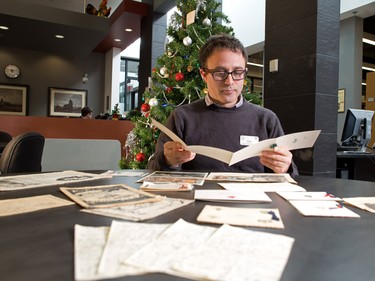 Archivist Jason Nisenson looks through old Christmas cards sent back home by soldiers during various wars at the Military Museums in Calgary on Tuesday December 20, 2016.
