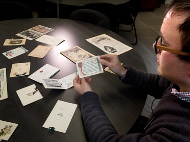 Archivist Jason Nisenson looks through old Christmas cards sent back home by soldiers during various wars at the Military Museums in Calgary on Tuesday December 20, 2016.