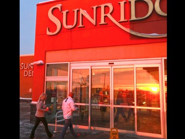 Shoppers head into check out the Sunridge Mall Boxing Day sales at sunrise on December 26, 2016.