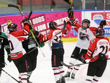 The CFR Chemical Bisons celebrate scoring on Alaska Oilers goaltender Jack Walters during their Mac's Midget Hockey Tournament game at the Max Bell Arenas on Tuesday December 27, 2016.