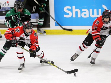 The CFR Chemical Bisons' Peyton Krebs, left and Jackson Salt move the puck up ice against the Alaska Oilers during their Mac's Midget Hockey Tournament game at the Max Bell Arenas on Tuesday December 27, 2016.