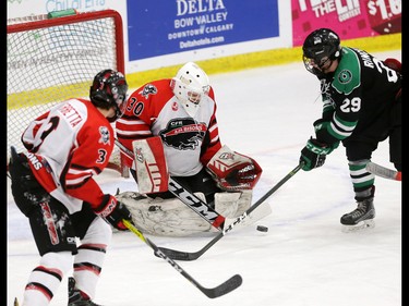 CFR Chemical Bisons goaltender Hunter Young stops this shot while Alaska Oilers forward Benjamin Rinckey looks for a rebound chance during a Mac's Midget Hockey Tournament game at the Max Bell Arenas on Tuesday December 27, 2016.