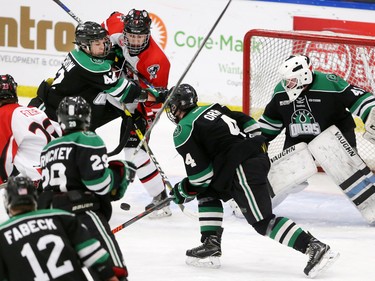 The CFR Chemical Bisons and Alaska Oilers scramble for a loose puck in front of Alaska Oilers goaltender Jack Walters in their Mac's Midget Hockey Tournament game at the Max Bell Arenas on Tuesday December 27, 2016.