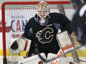 Calgary Flames goalie Nick Schneider blocks a shot during training camp at WInsport in Calgary, Alta. on Friday September 18, 2015. Jim Wells/Calgary Sun/Postmedia Network