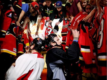 Calgary Flames Hunter Shinkaruk, left, and Brent Kulak sign autographs during the Flames SuperSkills at the Scotiabank Saddledomein Calgary, Alta., on Saturday December 3, 2016. Leah Hennel/Postmedia