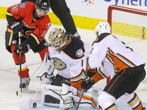 Calgary Flames Johnny Gaudreau tries to tap the puck past Anaheim Ducks goalie Jonathan Bernier as Ducks Kevin Bieksa moves in in NHL hockey action at the Scotiabank Saddledome in Calgary, Alta. on Sunday December 4, 2016. Mike Drew/Postmedia