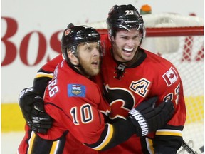 Calgary Flames Sean Monahan, right, celebrates his goal against the Columbus Blue Jackets with teammate Kris Versteeg at the Scotiabank Saddledome on Friday, Dec. 16, 2016.