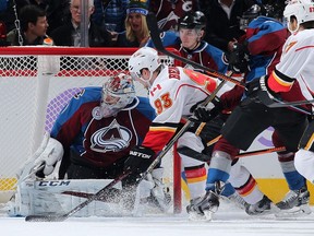 DENVER, CO - NOVEMBER 03:  Sam Bennett #93 of the Calgary Flames puts the puck past goalie Semyon Varlamov #1 of the Colorado Avalanche for a goal as the Avalanche held a 3-2 lead in the second period at Pepsi Center on November 3, 2015 in Denver, Colorado.