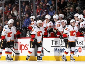 DENVER, CO - DECEMBER 27: Members of the Calgary Flames celebrate a goal against the Colorado Avalanche at the Pepsi Center on December 27, 2016 in Denver, Colorado.