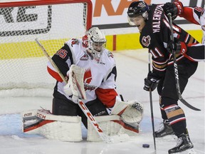 Calgary Hitmen Beck Malenstyn gets in close on Moose Jaw Warriors goalie Brody Wilms in WHL action at the Scotiabank Saddledome in Calgary, Alberta, on Friday, November 25. Mike Drew/Postmedia