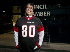 Calgary mayor Naheed Nenshi wears an obligatory smile while also wearing an Ottawa Redblacks jersey at City Hall in Calgary, Alta., on Monday, Dec. 5, 2016.