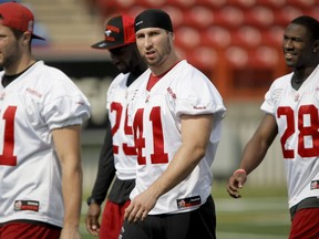 Calgary Stampeders defender Adam Thibault walks with teammates during a walk-through practice at McMahon Stadium in Calgary, Alta. on Friday, Aug. 8, 2014. The Calgary Stampeders would host the Ottawa RedBlacks the next day. Lyle Aspinall/Calgary Sun/QMI Agency