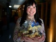 Cecilia Schlemm, Inn from the Cold communication co-ordinator, with packages of Lucky Stars cookies from Sunterra Market in Calgary. Sunterra is selling these homemade cookies for $5 with all proceeds going to the family homeless shelter.