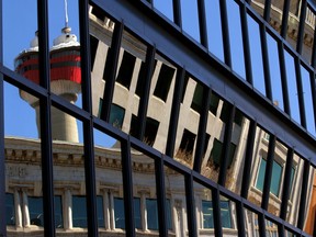 The Calgary Tower is reflected in the windows of the Municipal Building downtown.