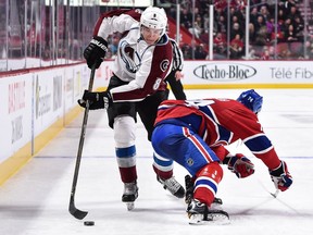 MONTREAL, QC - DECEMBER 10:  Alexei Emelin #74 of the Montreal Canadiens prepares to check Joe Colborne #8 of the Colorado Avalanche during the NHL game at the Bell Centre on December 10, 2016 in Montreal, Quebec, Canada.  The Montreal Canadiens defeated the Colorado Avalanche 10-1.