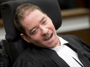 **EXCLUSIVE! PLEASE HOLD FOR VAL FORTNEY STORY, SLATED FOR OCT. 6, 2016 ** Greg McMeekin smiles while called to the bar during a ceremony at Calgary Courts Centre in Calgary, Alta., on Tuesday, Oct. 4, 2016. McMeekin was born with cerebral palsy, but he recently attained a law degree and, with this ceremony, became the most severely disabled Albertan ever to have been cleared to practice law. Lyle Aspinall/Postmedia Network