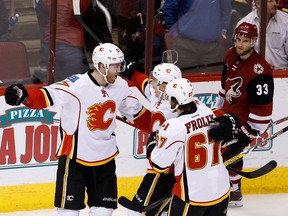 Johnny Gaudreau celebrates with Calgary Flames teammates after assisting on a goal against the Arizona Coyotes Thursday in Glendale, Arizona. Calgary won 2-1 in overtime. (Getty Images)