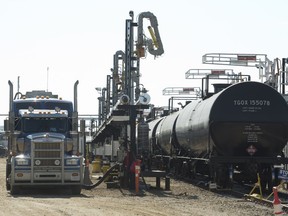 A semi unloads oil to be loaded into a rail car with oil at Canexus in Bruderheim, Alta.