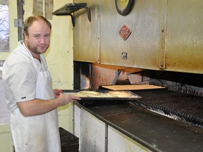 Forty years ago Glamorgan Bakery opened with Rudy Bootsma and 
Don Nauta as partners. Here, Steven Bootsma, Rudy’s grandson, takes Christmas Rings and Almond Sticks out of the original oven.