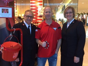 (Left to right) Lt Col. Larry Martin, Stampeders head coach Dave Dickenson and Captain Elizabeth Sanders try drive up donations and reach the $1-million mark with the Salvation Army’s Christmas Kettle Campaign.  Supplied photo