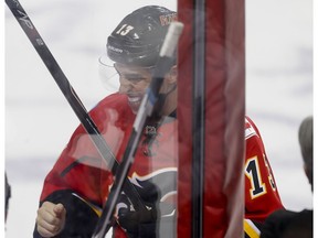 Johnny Gaudreau of the Calgary Flames grimaces after hurting his hand in the first period against the Minnesota Wild in Calgary, Alta., on Wednesday, Feb. 17, 2016.