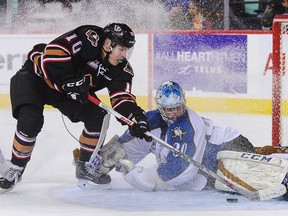CALGARY, AB - DECEMBER 18: Jakob Stukel #10 of the Calgary Hitmen takes a shot on Payton Lee #30 of the Kootenay Ice during a WHL game at Scotiabank Saddledome on December 18, 2016 in Calgary, Alberta, Canada.