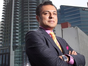 Riaz Mamdani, CEO of the Strategic Group, stands in front of the rendering of the group's highrise project on the site at 10th Avenue S.E. at 1st Street.