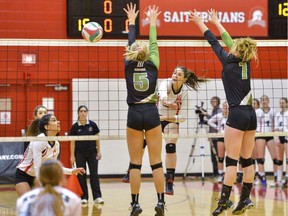 Megan Brennan, in white, a fifth-year outside hitter with Calgary's SAIT Trojans, became the ACAC all-time kills leader last year and holds the school mark for kills, digs and service aces. (Courtesy SAIT Athletics and Recreation)