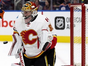 Calgary Flames' goaltender Jon Gillies (32) makes a save against the Edmonton Oilers during first period pre-season NHL action at Rogers Place, in Edmonton on Monday Sept. 26, 2016.