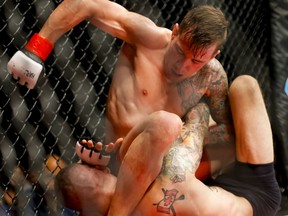 Owen Carr, top, of Team Alpha Male in Sacramento, Calif., fights Ryan Connor of Fit Plus Martial Arts in Dartsmouth, N.S., during HK43 at Markin McPhail Centre in Calgary, Alta., on Friday, May 22, 2015. Hard Knocks Fighting was hosting its 43rd championship, including a pair of title fights and a bout featuring former UFC fighter Nick Ring. Lyle Aspinall/Calgary Sun/Postmedia Network