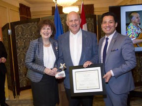 Calgarian Paul Finkleman receives a 2016 Volunteer Award at Government House in Edmonton from Culture and Tourism Minister Ricardo Miranda, and Lt.-Gov. Lois Mitchell.