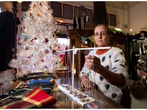 Ursula Wegen, owner of UTB Specialty and Fashion Shop, adjusts merchandise in her Bridgeland store. Calgary retailers are anxious to see what the Christmas shopping season brings, in the second year of recession. GAVIN YOUNG/POSTMEDIA