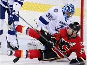 Calgary Flames forward Troy Brouwer collides with Tampa Bay Lightning goaltender Ben Bishop during NHL action at the Scotiabank Saddledome on Wednesday December 14, 2016.