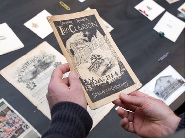 Archivist Jason Nisenson holds a Christmas newsletter produced by prisoners in a Second World War German prisoner of war camp. It is one of a variety of old Christmas cards and letters from soldiers during wartime at the Military Museums in Calgary.