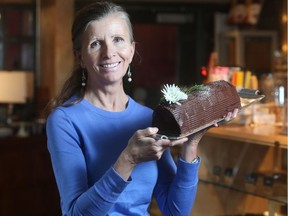Pam Fortier holds up a Decadent Yule Log, one of the Christmas delights at her bakery Decadent Brulee.
