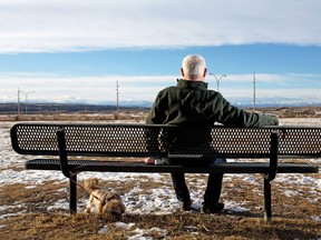 Laid-off oil and gas worker Gary Fraser stops to take in the view while walking his dog Piper on Wednesday December 21, 2016.  GAVIN YOUNG/POSTMEDIA