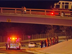 Police and EMS deal with a serious injury accident on the overpass from southbound Crowchild Trail to eastbound Glemore Trail on Tuesday evening December 27, 2016. First responders found one victim on the embankment below the overpass. GAVIN YOUNG/POSTMEDIA