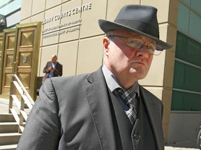 Disgraced former Calgary police officer Steve Huggett, shown here leaving court in Calgary, Alta on Friday June 5, 2015, has had his name removed from the national sex-offender registry, paving his way to move home to his native Britain.
Jim Wells/Calgary Sun/Postmedia Network