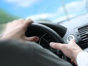 Over shoulder view of a man driving a car with his hands on the steering wheel, turning quick. (sunny weather) ORG XMIT: steering1221.jpg0