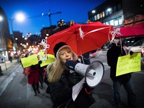 Joyce Arthur, a board member at the Providing Alternatives, Counselling and Education Society (PACE), leads a red umbrella march to recognize International Day to End Violence Against Sex Workers, in the Downtown Eastside of Vancouver, B.C., on Saturday December 17, 2016. The march, founded in 2003 after 50 women were murdered by serial killer Gary Ridgway, was held to bring attention to hate crimes committed against those working in the sex industry. THE CANADIAN PRESS/Darryl Dyck ORG XMIT: VCRD101