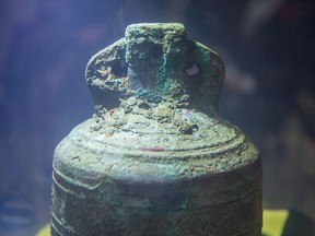 The ship's bell from the recently discovered Franklin Expedition shipwreck HMS Erebus sits in pure water after being recovered in Ottawa on Thursday, Nov. 6, 2014. New research has shed more light on one of Canada's enduring mysteries.