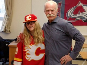 Julia Hird, 12, (L) whose brother Lukas Strasser-Hird was murdered outside a nightclub three years ago, poses Calgary Flames alumni Lanny McDonald.
