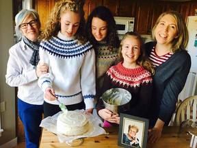 Cheryl Gibson, with glasses, with her daughter Anita Hofer on her left, and, to her right, grandchildren Katherine, Victoria and Ali. A photograph of Gibson’s mother, Solveig, is on 
the kitchen table.