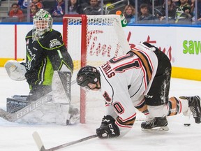 Edmonton Oil Kings goaltender Patrick Dea  watches Calgary Hitmen Jakob Stukel go wide with a shot during first period WHL action at Rogers Place, in Edmonton January 1, 2017.